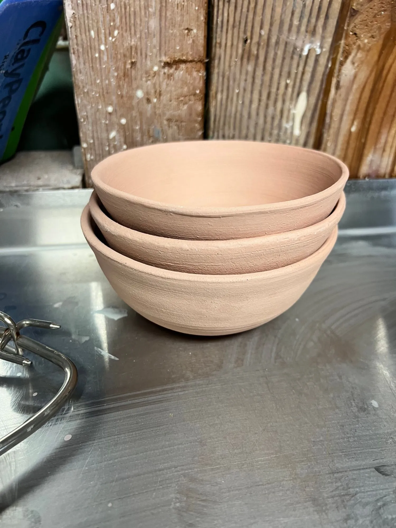 Three unglazed bowls stacked inside each other